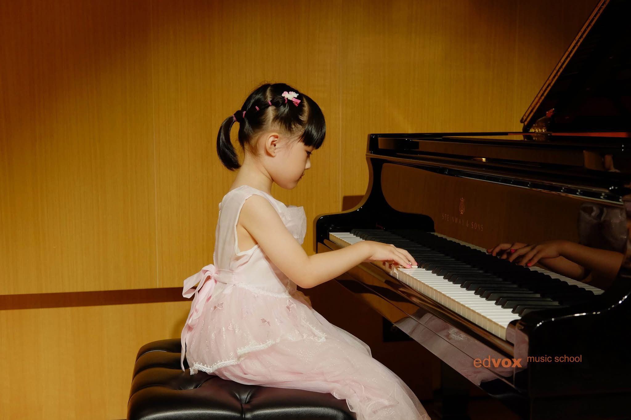 Teacher guiding young music learners